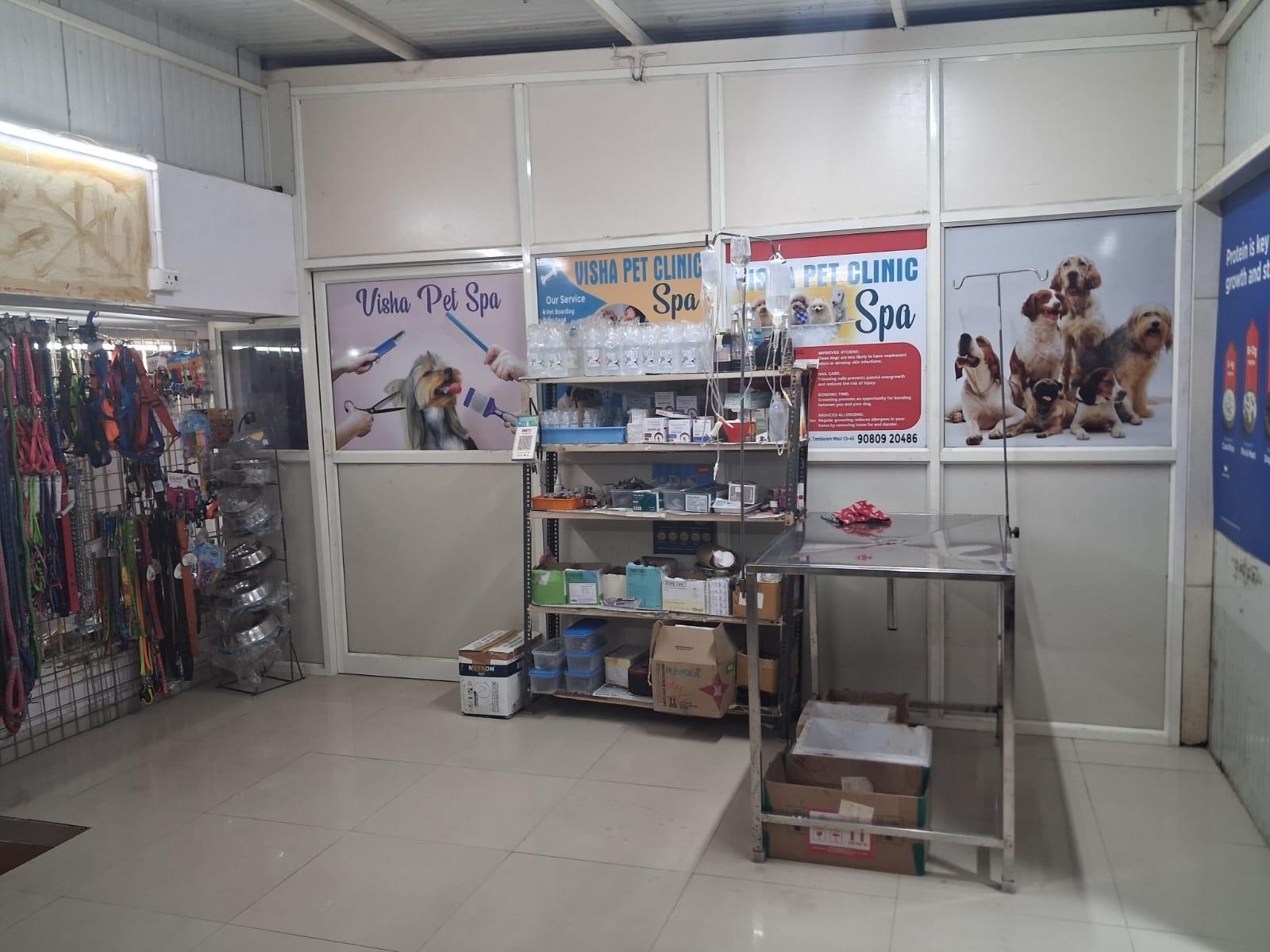 The Visha Pet Spa grooming corner, with the treatment table, IV stand and pharmacy shelving alongside it